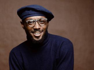 smiling black man wearing a turtleneck