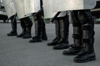 group of riot police staff in black boots standing