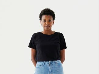 a woman standing her hands in her pockets
