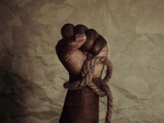 raised fist with a rope tied around the wrist 