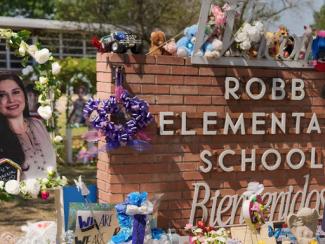 robb elementary school sign with flowers and memorials in front