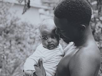 black father holding a young child