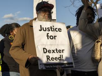 justice for dexter reed poster being held by a protester 