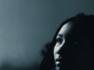 black woman staring off into distance