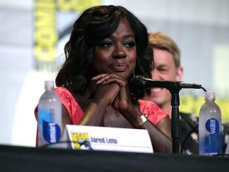 viola davis sitting at a table at a panel