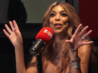 wendy williams sitting in front of a mic