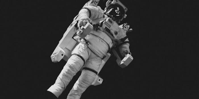 astronaut in white suit in grayscale
