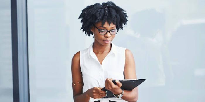 black woman in glasses with notepad