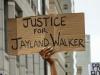 sign being held up that says justice for jayland walker