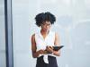 black woman in glasses with notepad