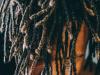 black child with dreads in front of face