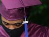 black graduate with a tassel hanging from their hat