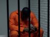 black prisoner waiting in a jail cell 