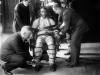 man sitting in a chair strapped